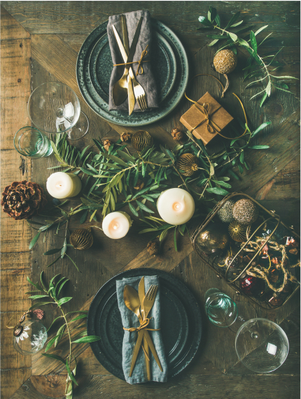 overhead shot of table with candles, foliage, and rustic napkins